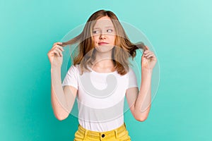 Photo portrait girl sad got splitted ends damaged hair need haircut isolated vibrant teal color background