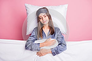 Photo portrait of girl wearing nightwear sleeping under soft blanket in bed isolated on pastel pink color background