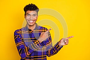 Photo portrait of handsome guy smiling showing fingers blank space cheerful isolated on vibrant yellow color background