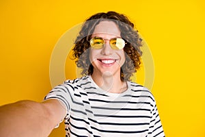 Photo portrait of handsome teenager guy toothy smile selfie photo sunglass wear trendy striped garment isolated on