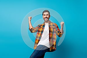 Photo portrait of handsome young male celebrate big sales shopping wear trendy plaid outfit isolated on blue color