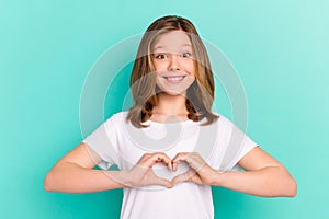 Photo portrait little girl happy showing heart sign with hands isolated vivid turquoise color background