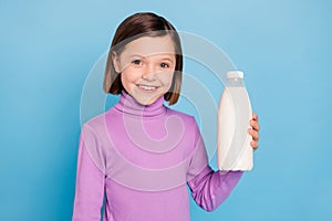 Photo portrait little girl smiling keeping bottle with milk isolated pastel blue color background