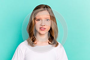 Photo portrait little girl unhappy displeased grimacing wearing white t-shirt isolated vibrant teal color background