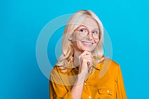 Photo portrait of lovely retired lady minded look empty space wear trendy orange smart casual garment isolated on blue