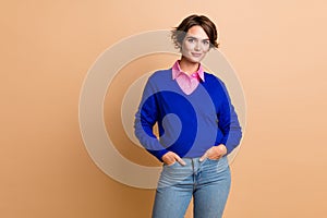 Photo portrait of lovely young lady hands pockets shopping posing dressed stylish blue garment isolated on beige color