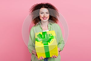 Photo portrait of lovely young lady hold giving big giftbox dressed stylish green garment isolated on pink color