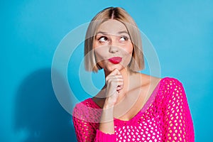 Photo portrait of lovely young lady look minded empty space dressed stylish pink knitwear garment  on blue color