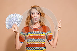 Photo portrait of lovely young lady look shocked money point empty space dressed stylish striped garment isolated on