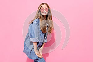 Photo portrait of lovely young teenager lady defile posing shopping model wear trendy jeans garment isolated on pink