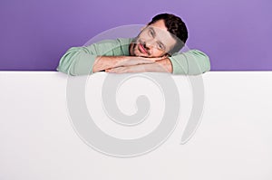 Photo portrait of nice young man lean lay empty space promo poster wear trendy gray garment isolated on violet color