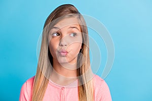 Photo portrait of pouting girl looking at blank space isolated on pastel blue colored background