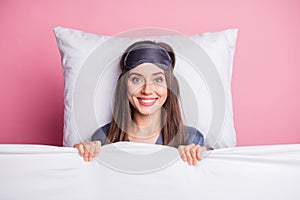 Photo portrait of pretty brunette wearing nightwear chilling laying under blanket in bed isolated on pastel pink color