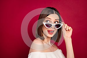 Photo portrait pretty brunette wearing sunglass licking lips looking copyspace isolated red color background