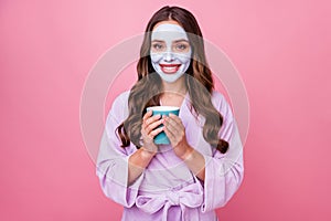 Photo portrait of pretty cute girl doing treatment procedures for skin wearing facial mask holding cup of coffee wearing