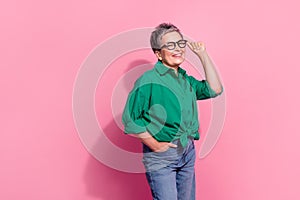 Photo portrait of pretty retired female touch specs defile shopping promo wear trendy green outfit isolated on pink