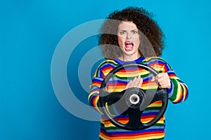 Photo portrait of pretty young girl beep horn steering wheel traffic jam wear trendy rainbow print outfit isolated on photo