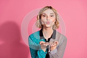 Photo portrait of pretty young girl send you air kiss wear trendy striped cyan outfit isolated on pink color background