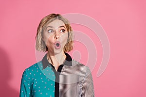 Photo portrait of pretty young girl shocked face look empty space wear trendy striped cyan outfit isolated on pink color