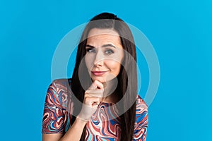 Photo portrait of pretty young girl skeptical look wear trendy colorful clothes isolated on blue color background
