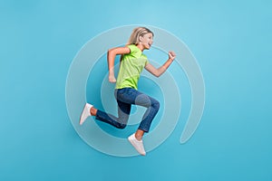 Photo portrait profile of girl running jumping up  on pastel blue colored background