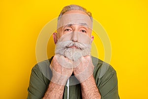 Photo portrait of senior man thoughtful sad face in green shirt isolated bright yellow color background