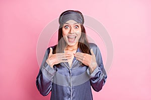 Photo portrait of shocked screaming girl touching chest with two hands isolated on pastel pink colored background