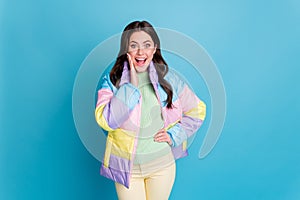 Photo portrait of shocked screaming woman touching face with one hand isolated on pastel blue colored background