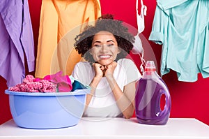 Photo portrait woman laughing near clean clothes washing bottle isolated vivid red color background