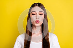 Photo portrait of woman sending air kiss closed eyes on date isolated vibrant yellow color background