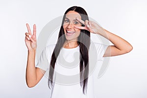 Photo portrait of woman smiling showing happy peace v-sign gesture isolated on white color background