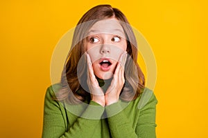 Photo portrait young girl in green turtleneck surprised touching cheeks looking empty space  vivid green color