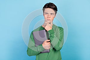 Photo portrait young guy keeping laptop looking copyspace thoughtful contemplated isolated pastel blue color background