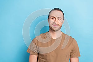 Photo portrait of young minded thoughtful man wear brown t-shirt sceptic looking empty space gloomy distrust news