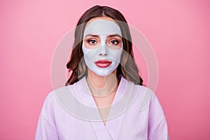 Photo portrait of young woman with brown wavy hair applied nourishing mask on smooth skin doing spa procedures isolated