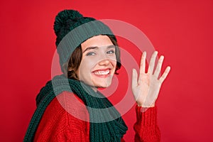 Photo portrait young woman waving hand wearing knitted headwear scarf isolated vibrant red color background