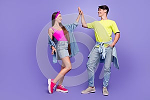 Photo of positive buddie couple high-five team win concept wear pin-up outfit isolated purple color background