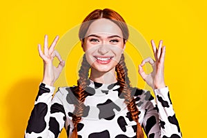 Photo of positive charming lady dressed cowskin top showing two okey signs isolated yellow color background