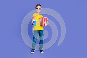 Photo of positive cheerful boy wear stylish yellow clothes hold food enjoy weekend watch 3d cinema  on purple