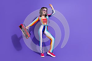Photo of positive cheerful lady hold boom box dancing discotheque isolated on purple color background