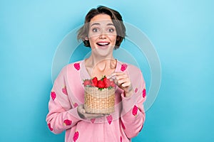 Photo of positive cute girl wear pink stylish clothes hands hold fresh strawberry basket yummy vitamins isolated on blue