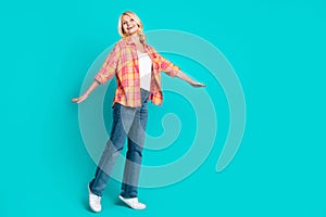 Photo of positive cute senior woman wear nice stylish clothes empty space  on cyan color background