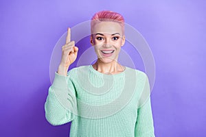 Photo of positive excited girl wear turquoise sweater pointing finger up having great idea isolated violet color