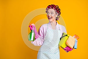 Photo of positive girl hold spray bottle bucket look copyspace wear bath robe isolated bright color background