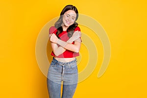 Photo of positive girl hug herself self care concept isolated over bright color background