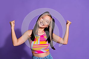 Photo of positive glad girl wear trendy clothes celebrate success isolated on purple color background