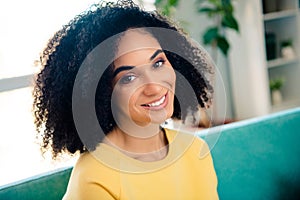 Photo of positive gorgeous optimistic woman with perming coiffure wear yellow long sleeve toothy smiling on camera at