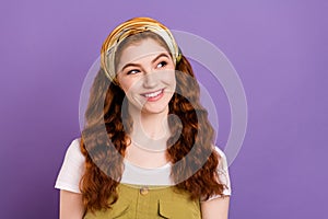 Photo of positive happy dreamy young woman look empty space good mood isolated on purple color background