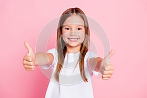 Photo of positive kid girl show thumb up sign enjoy new school promotion recommend suggest select wear good look clothes