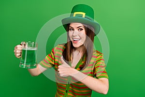 Photo of positive lady in leprechaun suit advertise thumb up reaction to patrick ale lager glass isolated green color